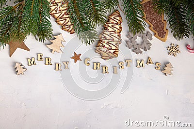 Merry Christmas written with wooden letters, cookies and Christmas decorations Stock Photo