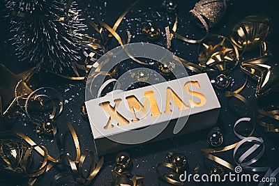 Merry christmas,xmas and celebration concepts with xmas lightbox text and ornament in golden color on dark Stock Photo
