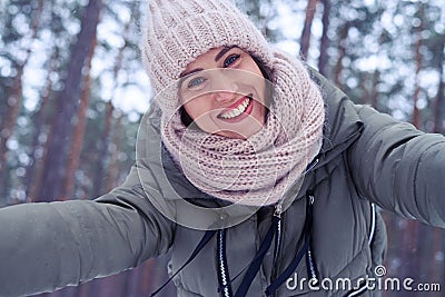 Merry female smiling at the camera spreading two hands Stock Photo