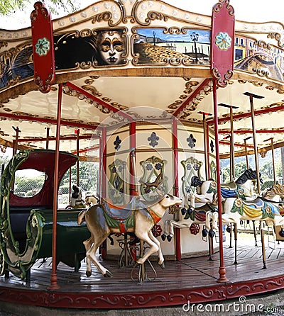 Merry-go-round. Carousel. Playground. Traditional game for children. Amusement park. A merry-go-round with horses, reindeer and sl Editorial Stock Photo