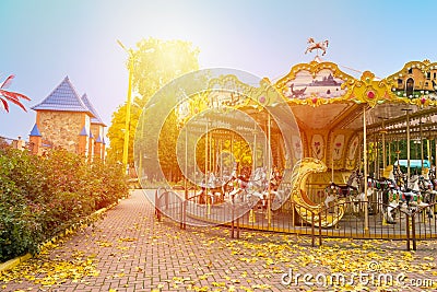 Merry-round-go Horse Carousel in Autumn park. Fall landscape wit Stock Photo