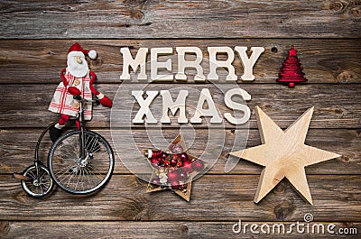 Merry Xmas greeting card with text. Red Santa Claus on wooden ru Stock Photo