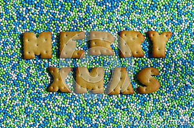 Merry Xmas. The word from the edible letters lies on the glazed Stock Photo