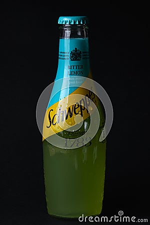 Mersin, Turkey - February 2020. Chilled bitter lemon Schweppes bottle with drops and inscriptions on Turkish at black Editorial Stock Photo