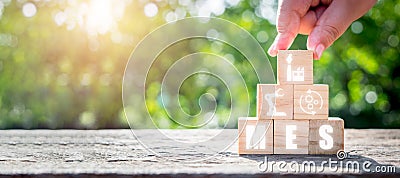 MES - Manufacturing Execution System concept, Man hand holding wooden cube block with Manufacturing Execution System icon on Stock Photo