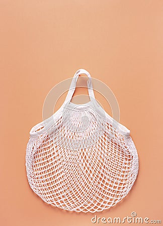 Mesh bag rests on a peach surface Stock Photo