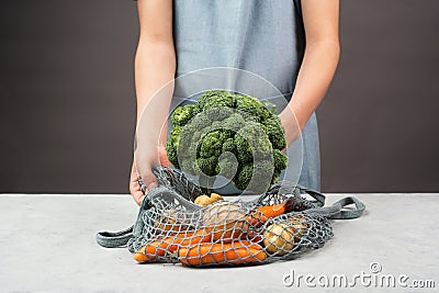 Mesh bag with vegetables, shopping grocery, healthy food ingredients, potato, broccoli and carrots, zero waste Stock Photo