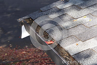 Mesh on home rain gutters keeping leaves out Stock Photo