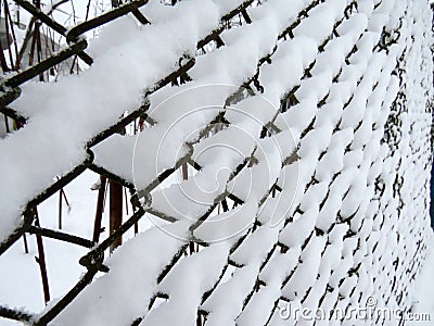 Mesh netting covered with snow Stock Photo