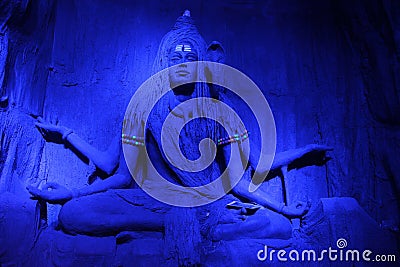 Mesmerising sculpture of Lord Shiva meditating in a blue light during Ganpati Festival, Pune Stock Photo