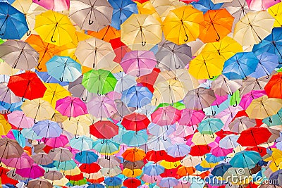 A mesmerizing display of countless colorful umbrellas creating a stunning canopy overhead. Perfect for concepts related to Editorial Stock Photo