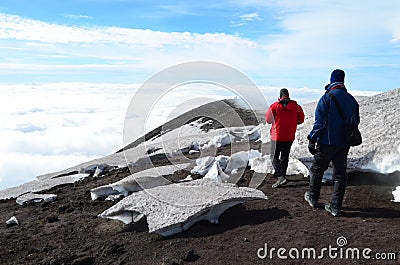 Mesmerizing shot of two tourists visiting Etna volcano in Sicily, Italy Editorial Stock Photo