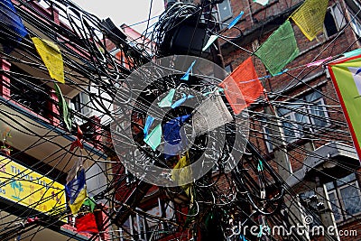 Mess of wires and prayer flags in Kathmandu Editorial Stock Photo