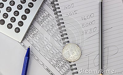 Mess on your desktop. Calculator, notebook, documents, Bitcoin Stock Photo