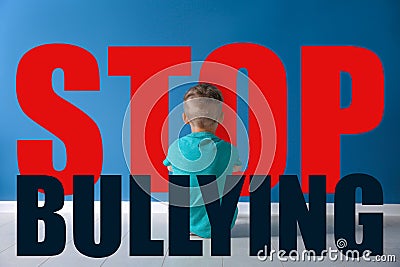 Message STOP BULLYING and sad little boy sitting Stock Photo