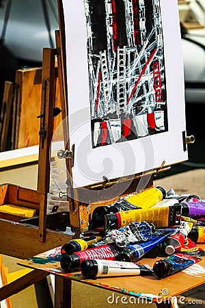 Messy artist`s easel with canvas painted Editorial Stock Photo