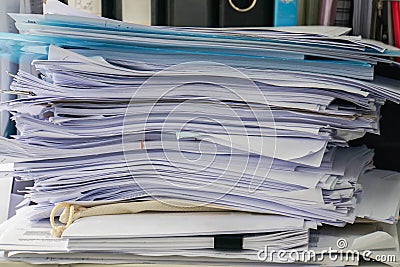 Messy business documents piles on office desk Stock Photo