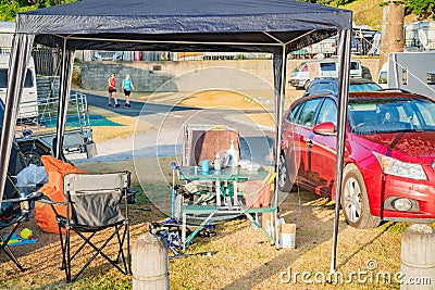 Messy family campsite with chairs table and other things Editorial Stock Photo