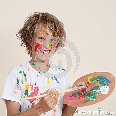 Messy kid with paint pallete Stock Photo