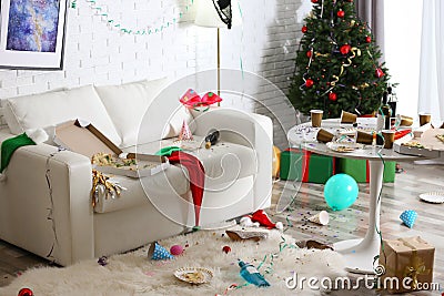 Messy room interior with Christmas tree. Chaos after party Stock Photo