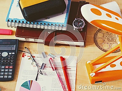 Messy Office desk laptop calculator diary lamp budget debit credit cards Stock Photo