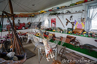 Messy room of vintage American toys and wooden rocking horses Editorial Stock Photo