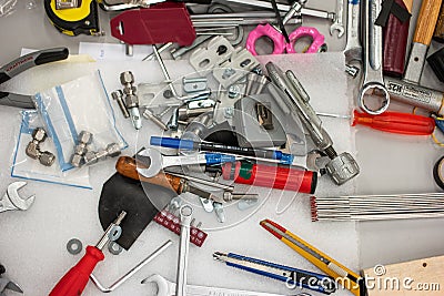 Messy tool desk top view scattered and unorganized work tools no people Stock Photo