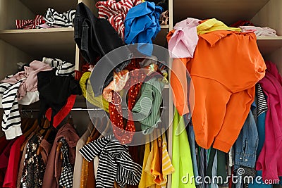 Messy wardrobe with different clothes. Fast fashion concept Stock Photo