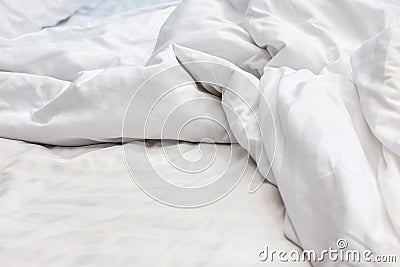 Messy white bedding sheet after waking up in the morning Stock Photo