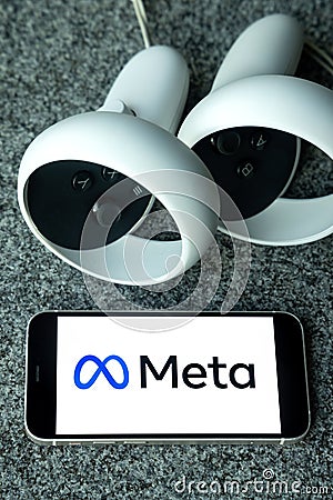 META company logo on smartphone next to Oculus joy cons, touch controllers. Editorial Stock Photo