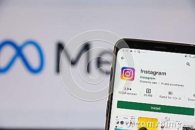 Meta Facebook logo, Instagram mobile app installed on smartphone. Copy space to the left. Popular apps from Google Play. Selective Editorial Stock Photo
