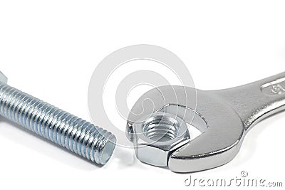 Metal Bolt And Chrome-Vanadium Spanner Gripping Nut Isolated On White Background Stock Photo