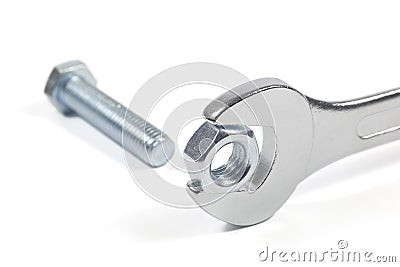 Metal Bolt And Chrome-Vanadium Spanner Gripping Nut Isolated On White Background Stock Photo