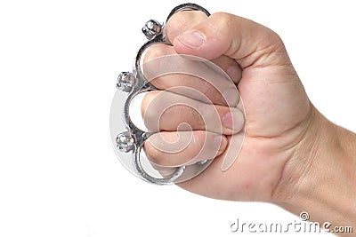 Metal brass knuckles cold steel worn on fist, white background. Stock Photo