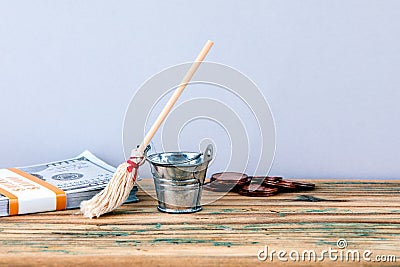 Metal bucket, money and broom Stock Photo