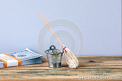 Metal bucket, money and broom Stock Photo