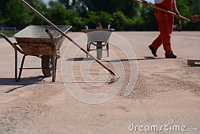 Metal cart with rakes on construction site Stock Photo