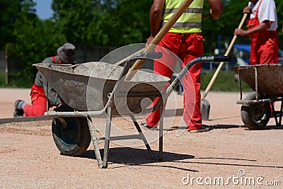 Metal cart with shovel on construction site Stock Photo