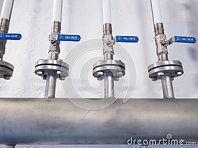 Metal chrome pipe with flange and set of valves. Industrial concept Stock Photo