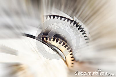 Metal Cogwheels in clock mechanism , abstract sun beams. Macro Stock Photo