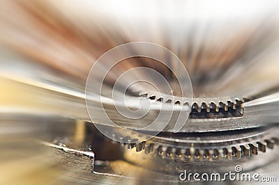 Metal Cogwheels in clock mechanism , abstract sun beams. Macro Stock Photo
