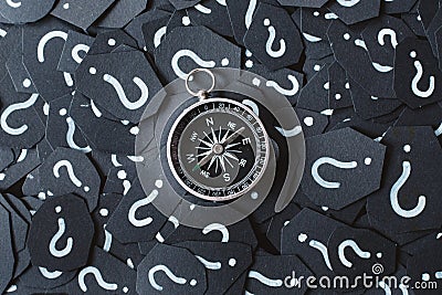 Metal compass on question mark background. Stock Photo