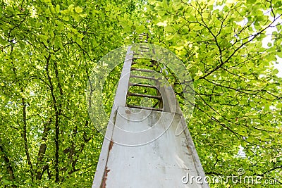 Metal construction in front of a tree Stock Photo