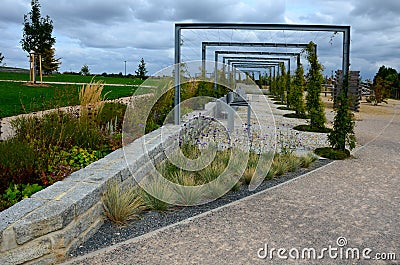 From metal constructions to climbing plants and vines is a sitting terrace of rough stone paving chipped cubes. metal gray furnitu Stock Photo