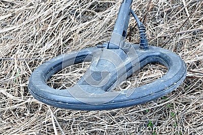 Metal detector. Search for metal artifacts on a field with damaged grass Stock Photo