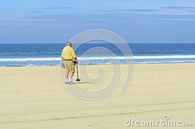 Metal detectorist on Pacific Beach Editorial Stock Photo