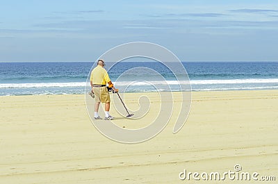 Metal detectorist on Pacific Beach Editorial Stock Photo