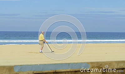 Metal detectorist on Pacific Beach Editorial Stock Photo