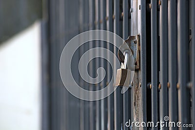 Metal door fence being locked. Concept of going away from and feeling missing home Stock Photo