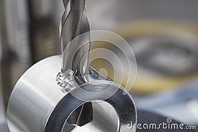 Metal drill bit make holes in aluminium pipe on industrial drilling machine. Metal work industry Stock Photo